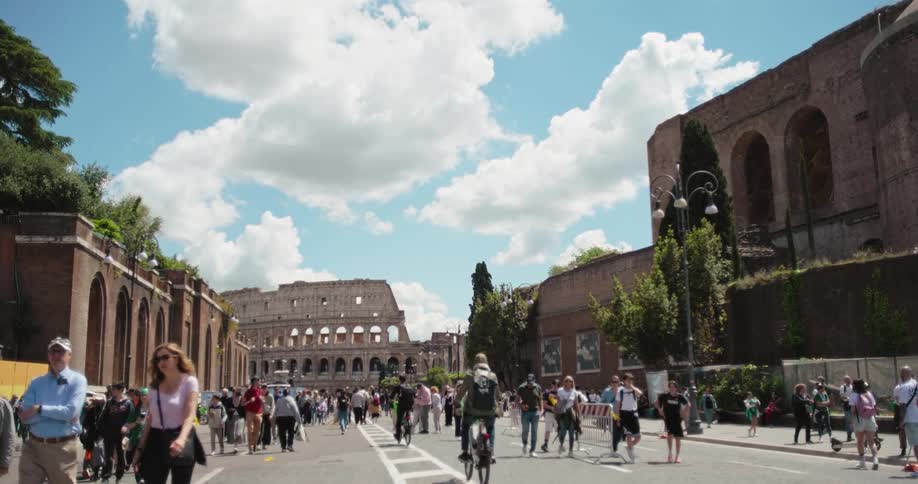 A busy street in rome filled with tourists during daytime