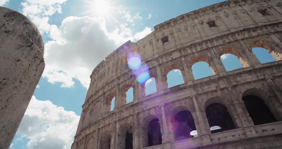 Side view of the colosseum in rome with details of the arches under the blue sky