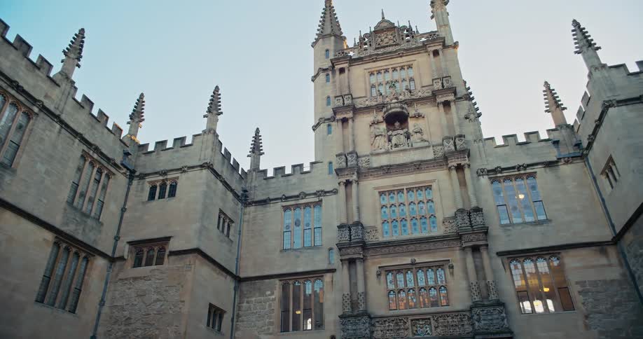 The tall stone building has many windows