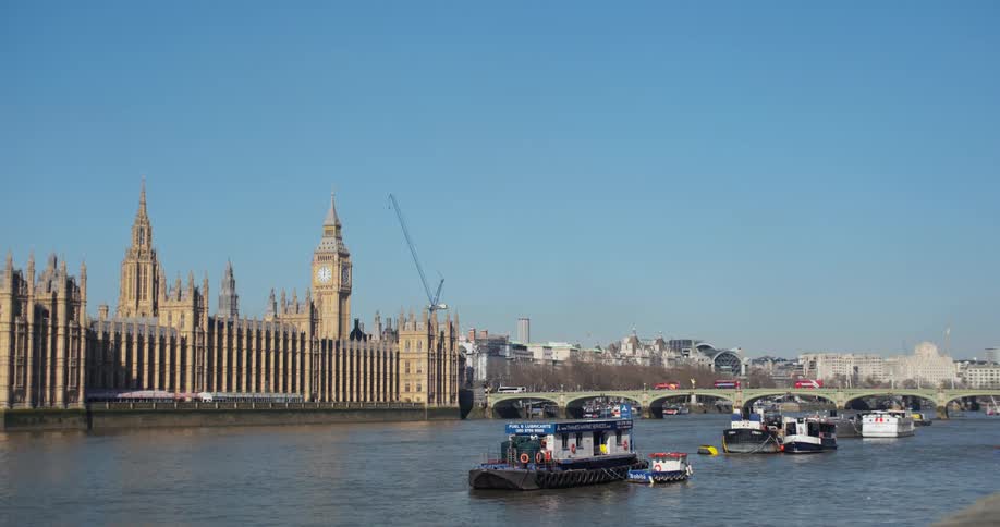 Boats are anchored by the large stone building
