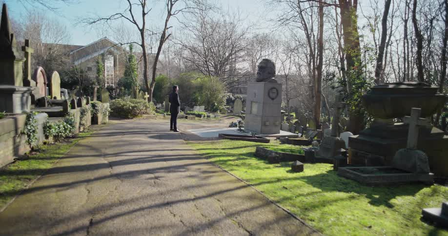 A man is standing in the graveyard