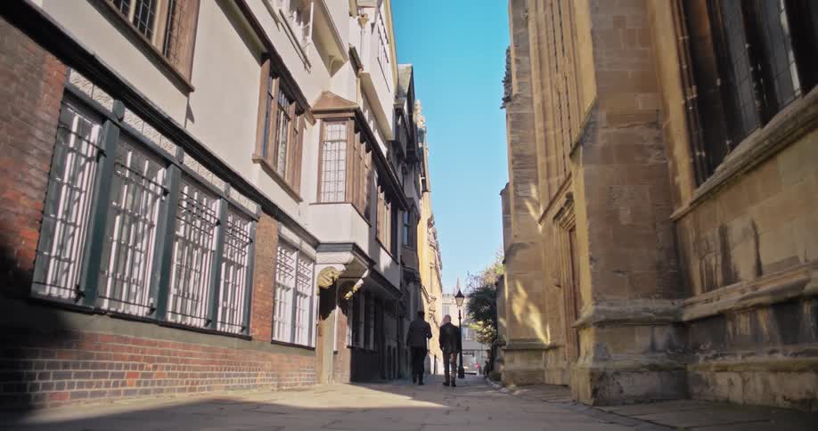 Two men walk down the alley in the city