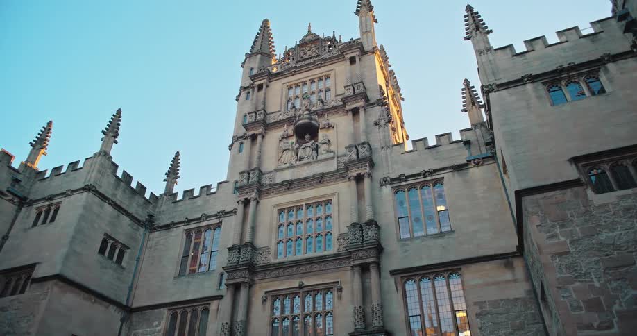 Facade of a historic gothicstyle building with ornate towers and large windows