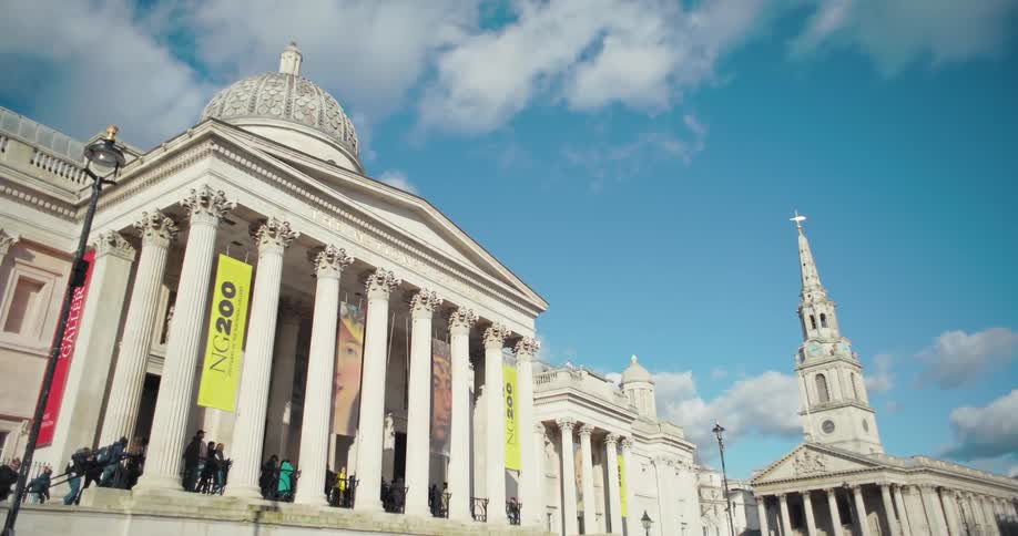 Facade of the national gallery in london with commemorative banners hanging from the columns