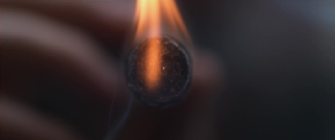 Match igniting a cigarette in slow motion