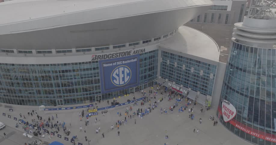Entrance of bridgestone arena in nashville with people gathered for an sec basketball event