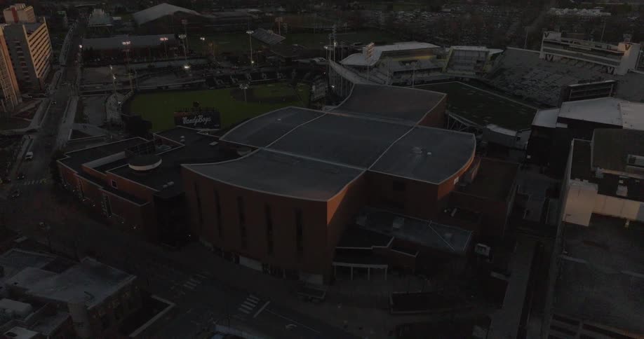 An aerial view at dusk shows a sports complex in nashville including firstbank stadium and hawkins field