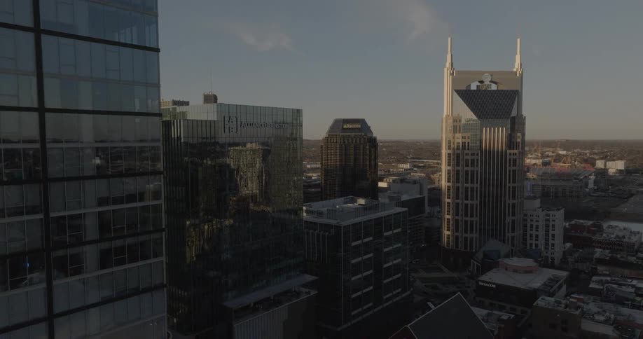 Taller buildings cast shadows onto the lower buildings in downtown on a slightly cloudy day