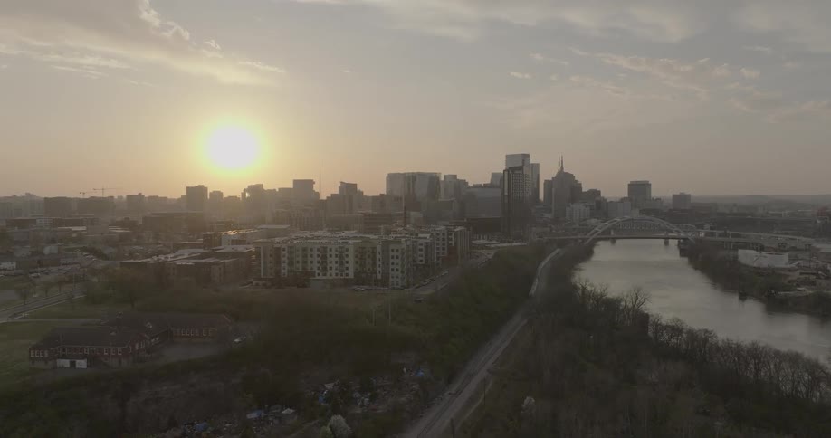 Aerial view of the city at sunset with a river running through the urban center