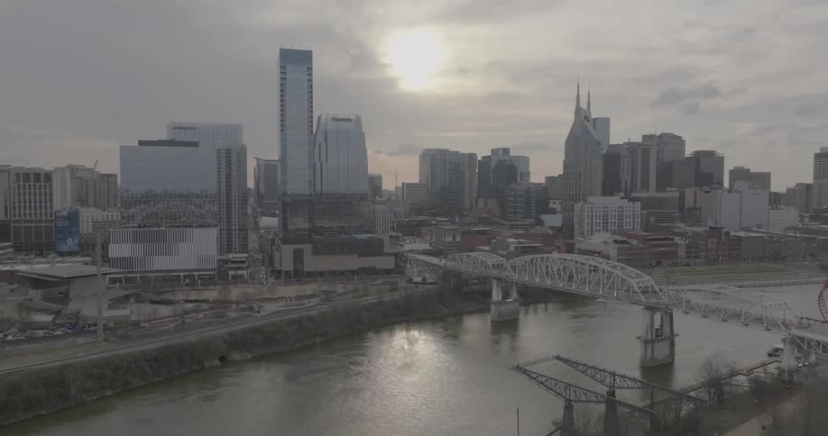 Aerial view of downtown nashville tennessee highlighting the john seigenthaler bridge over the cumberland river at sunset
