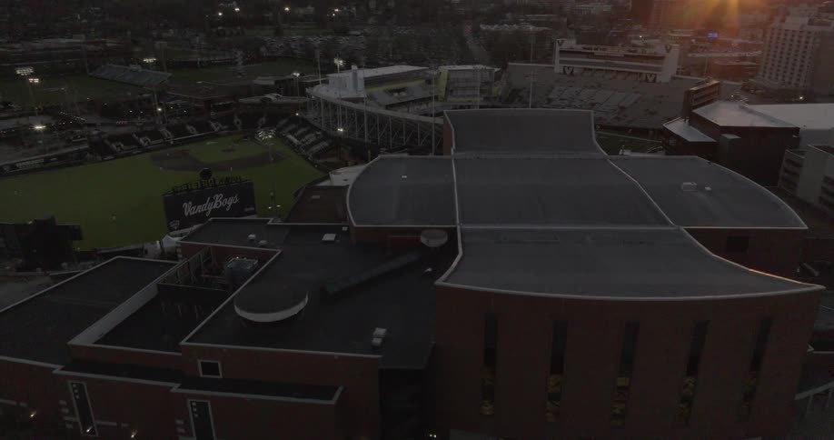 A sports stadium in the city at dawn surrounded by other sports facilities
