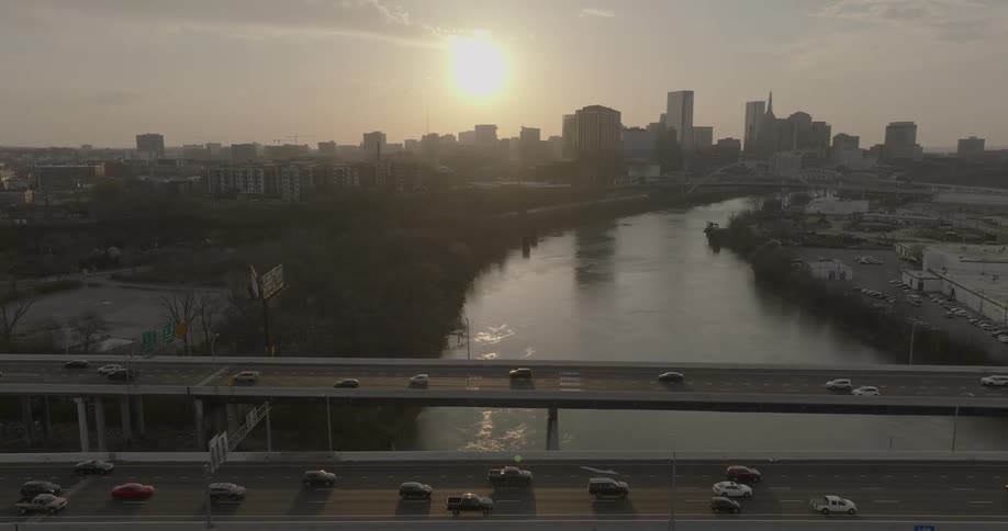 Aerial of a busy freeway and overpass in a metropolitan city during daytime