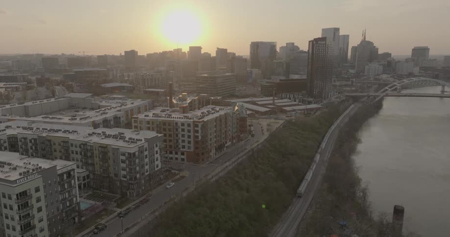 Aerial view of nashville at sunset showing buildings a bridge and the cumberland river