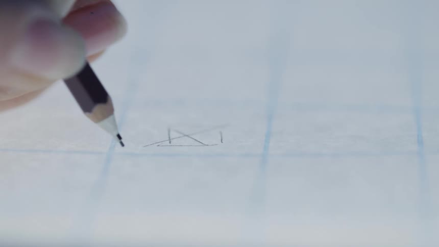 Pencil draws geometric shapes on graph paper