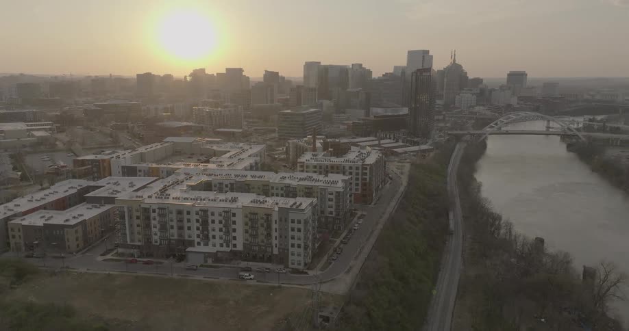 Aerial view of nashville at sunset with the cumberland river and buildings on the horizon