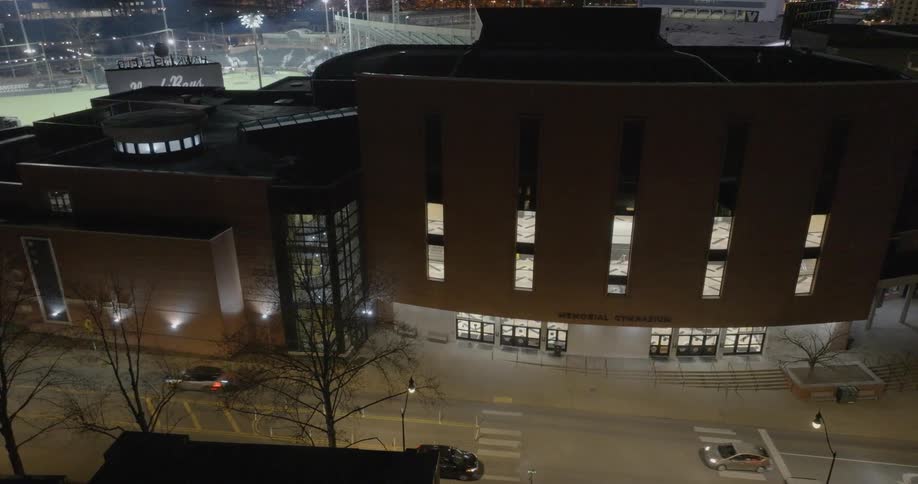 An aerial view of bridgestone arena in downtown nashville at sunset shows crowds gathered and people walking nearby