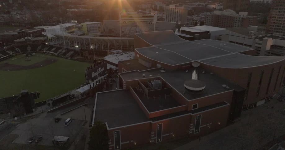 Aerial of a sport stadium in a busy metropolitan city at sunset