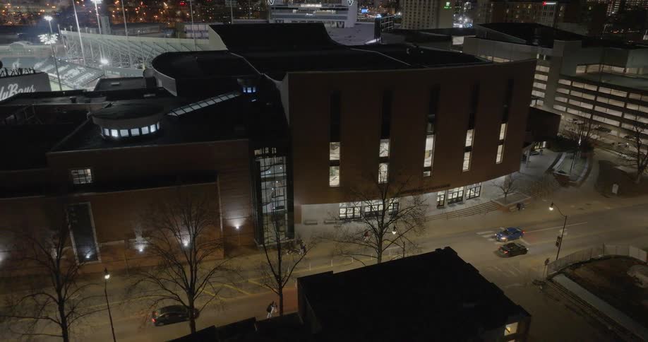 Night aerial view of an illuminated urban complex with the vandyboys baseball stadium visible on the left