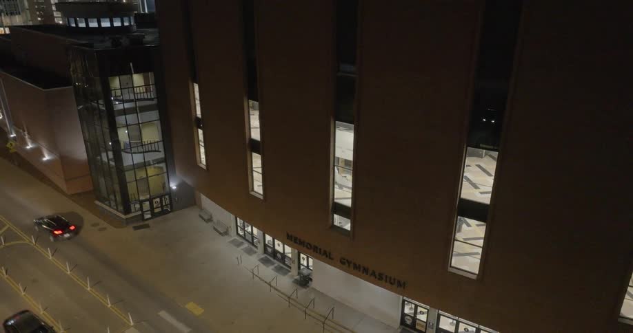 Night view of the memorial gymnasium facade illuminated