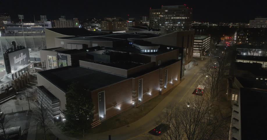 Aerial of vehicles moving along a busy street in metropolitan city at night