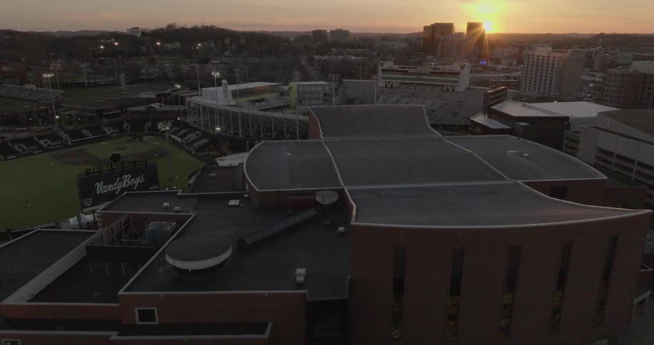 An aerial view of downtown nashville at sunset reveals bridgestone arena the att building and the music city center amid bustling streets and lively crowds