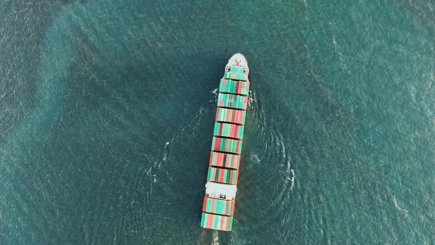 Cargo ship carrying colorful containers across the open sea