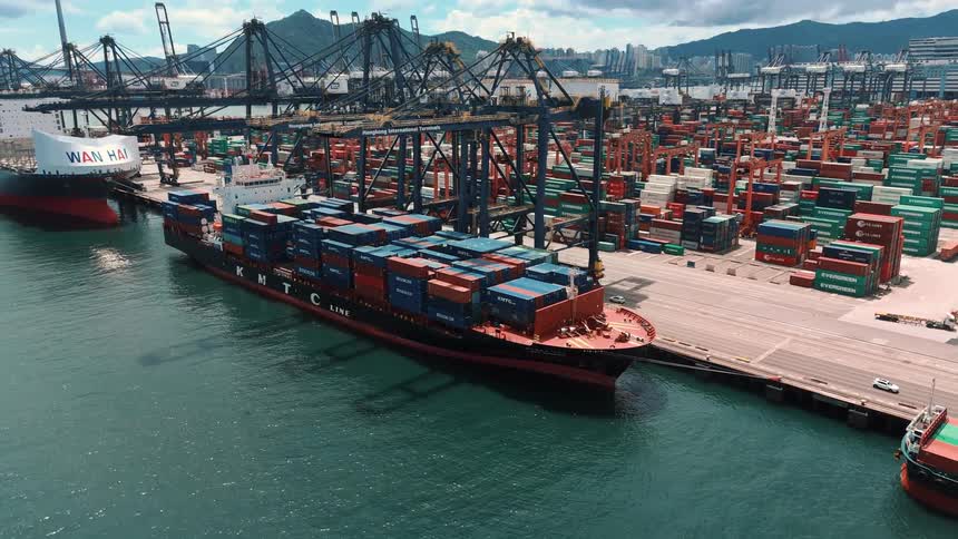 Kmtc line cargo ship docked at a port with numerous stacked containers