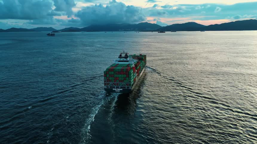 Ever crown container ship sailing in open waters at sunset