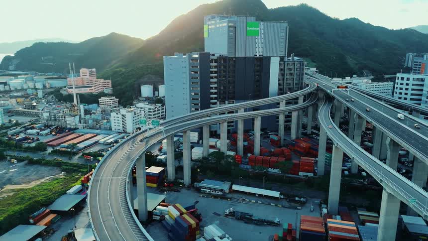 Elevated overpass winds above colorful containers in a port area