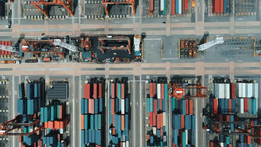 Aerial view of colorful containers arranged in rows at the port terminal