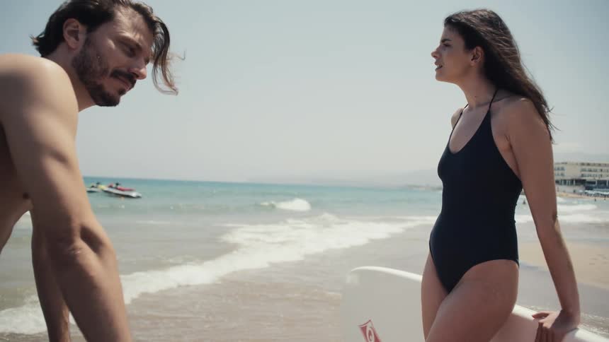 Man and woman are talking on the beach