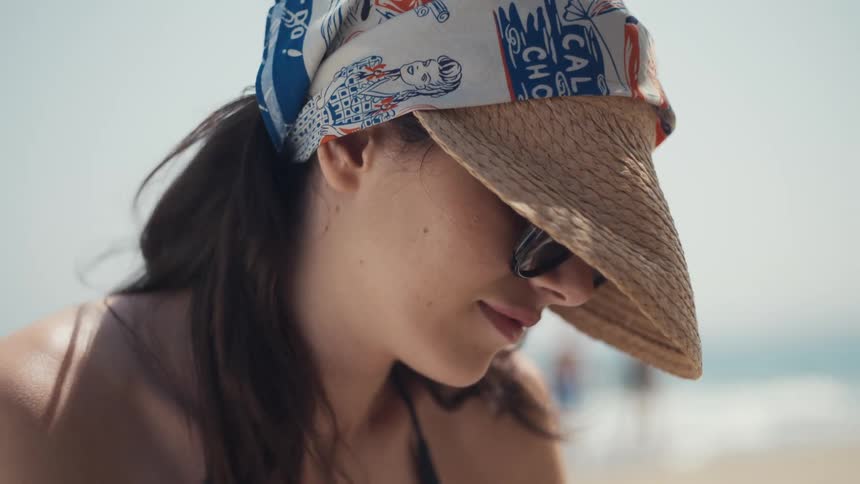 The woman is smiling on the beach