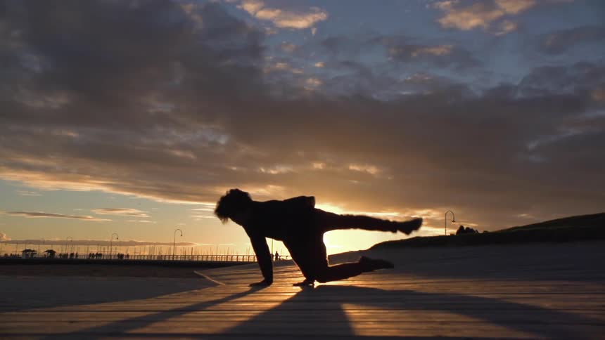 Person dancing as the sun sets