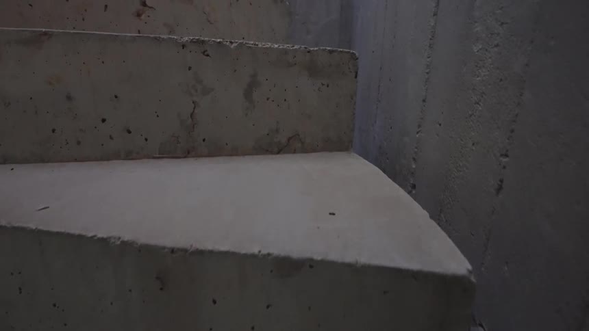 Concrete staircase with cement walls around it