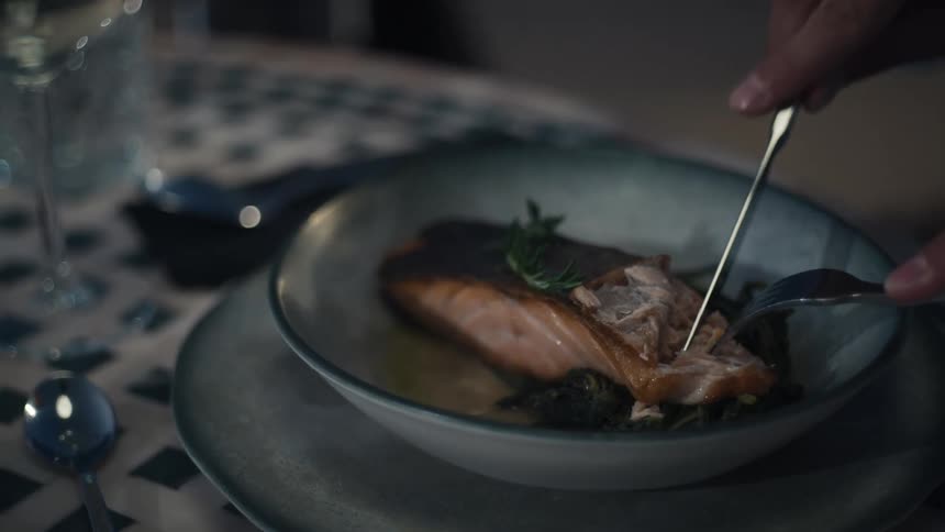 A man is cutting food on his dish