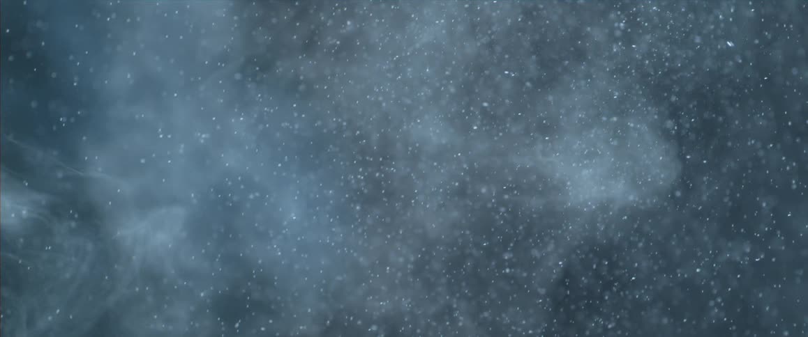 Close up of small white flakes flying in a sky