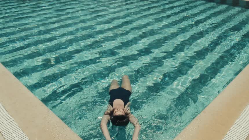 A woman floats in a pool