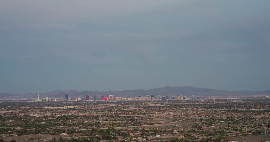 Panorama of an urban city with skyscrapers and mountains on the horizon