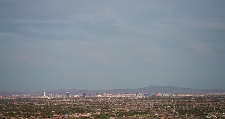 The landscape leads to a skyline of tall buildings