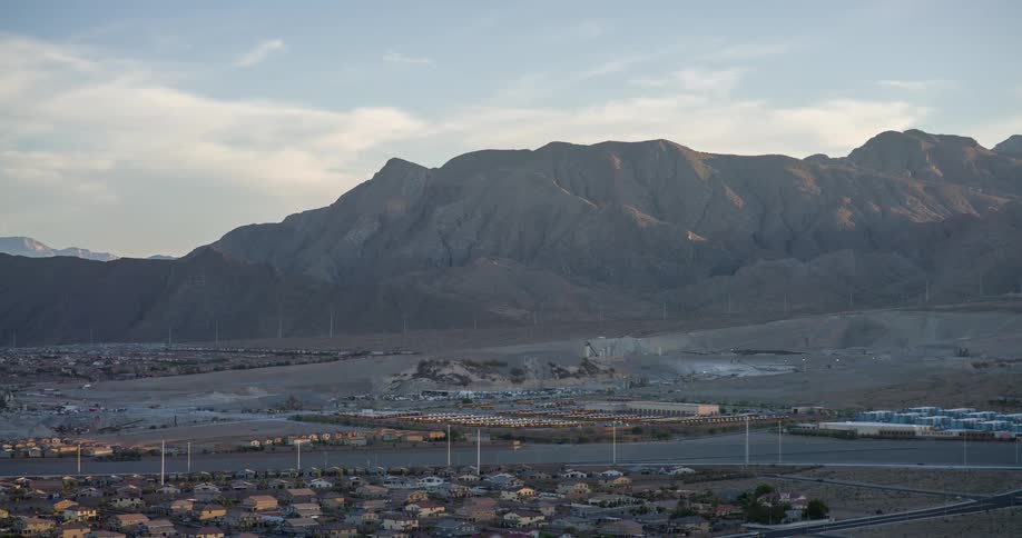Urban city in an area surrounded by mountains seen at dawn