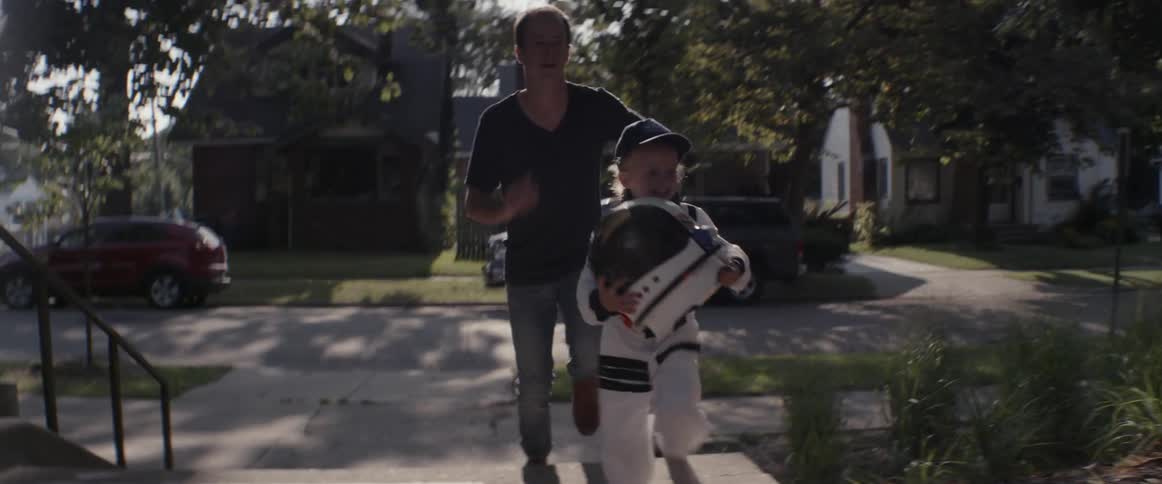 A man and child race up some steps