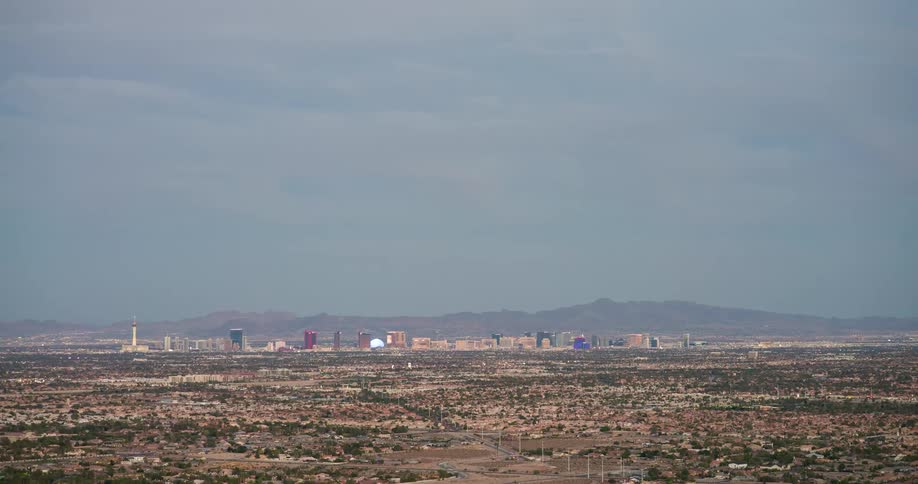 A cityscape covering a large area filled with buildings and various structures at midday