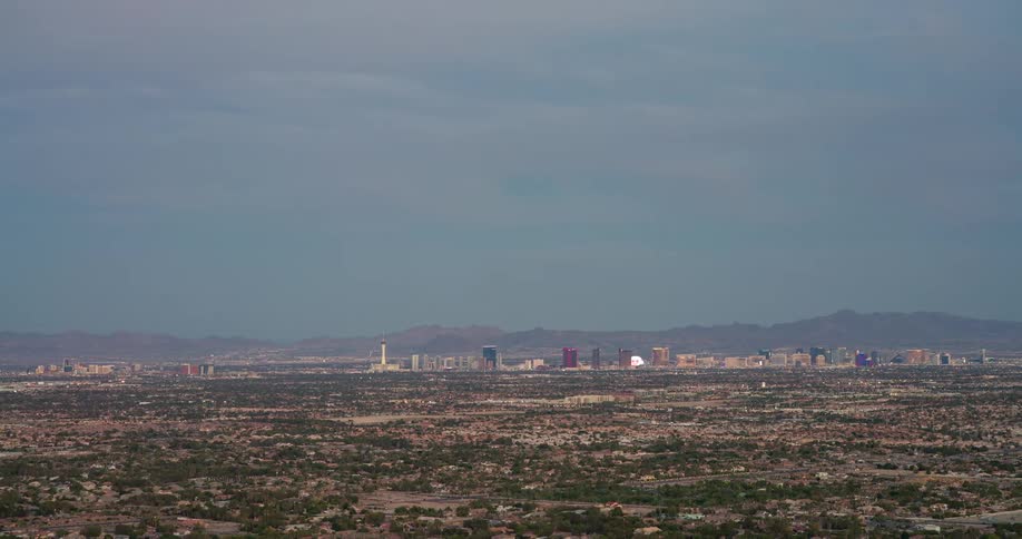 A cityscape covering a large area filled with buildings and various structures at midday