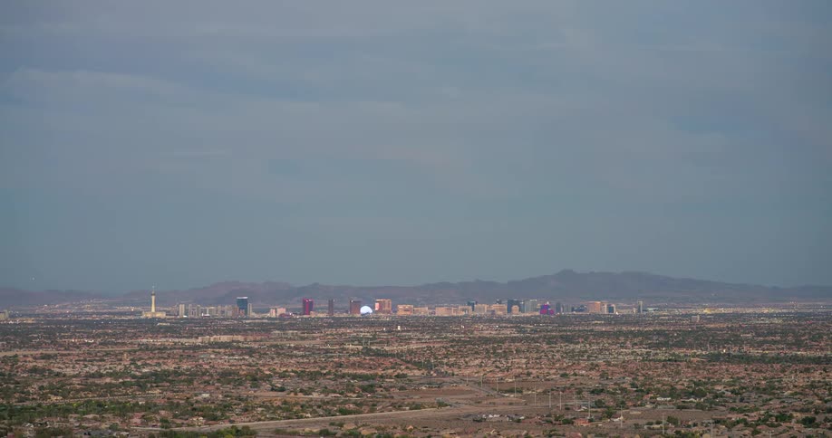 A cityscape covering a large area filled with buildings and various structures at midday