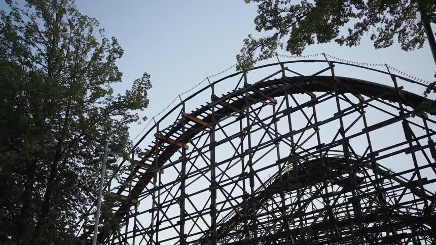 People ride on the rollercoaster in the amusement park