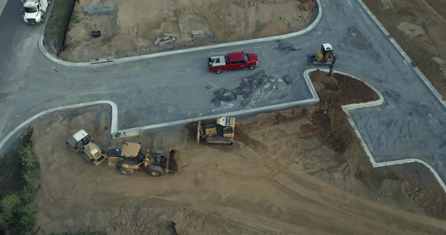Construction vehicles drive on the work site