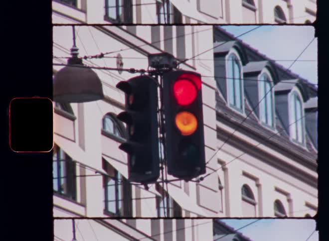 Downtown traffic signal changing from red to yellow to green