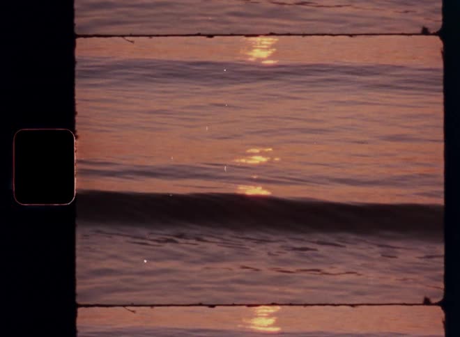 Small waves rolling in as the sunset reflects off the ocean