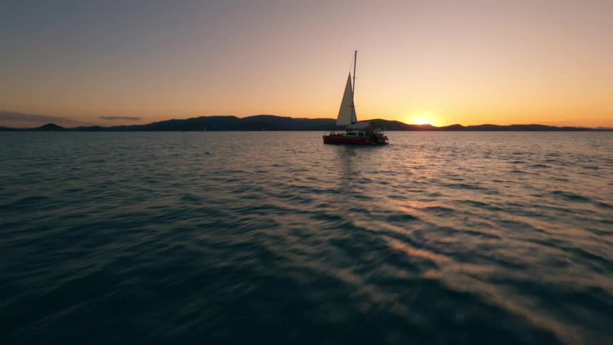 Sailboat sailing on the sea at sunset