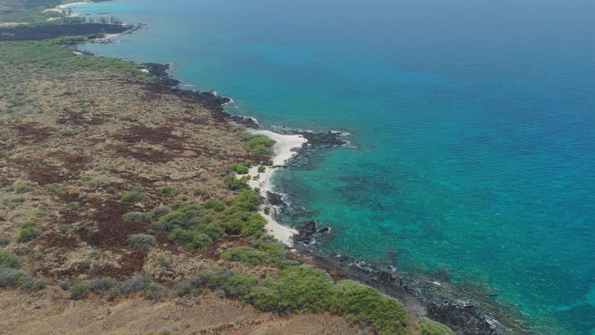 Aerial view of a turquoise sea on a beach by the coast
